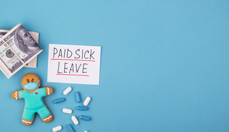 Money, medicine and gingerbread man in a mask inscription paid sick leave. family medical leave act...