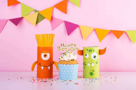 Birthday of a funny monster with a cake. handmade paper monsters. halloween partyの写真素材