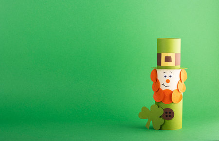 Green cute Leprechaun made of handmade paper on a green background, space for text. Cultural and religious holiday St. Patrick's dayの写真素材