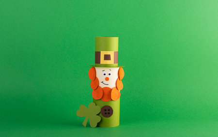 Green cute Leprechaun made of handmade paper on a green background, space for text. Cultural and religious holiday St. Patrick's dayの写真素材