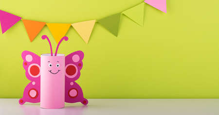 cute paper butterfly made from a toilet paper tube. spring background. recyclingの写真素材