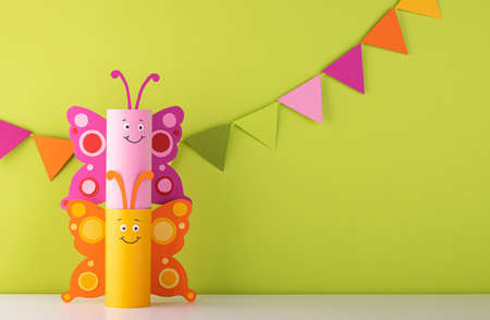 cute paper butterfly made from a toilet paper tube. spring background. recyclingの写真素材