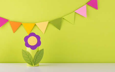 beautiful handmade paper flower on green background. fresh spring and summer backgroundの写真素材