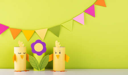 beautiful paper flower with cute handmade birds on green background. fresh spring and summer backgroundの写真素材