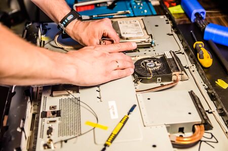 man disassembles monoblock for repair and cleaningの写真素材