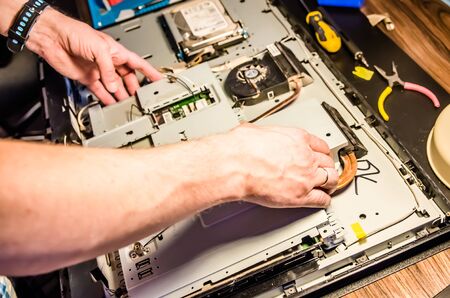 man disassembles monoblock for repair and cleaningの写真素材