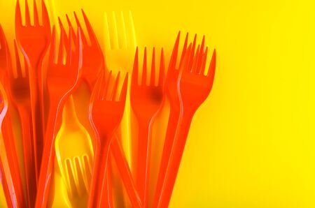 concept plastic utensils on a yellow background with copy spaceの写真素材
