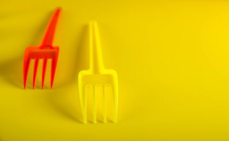 concept plastic utensils on a yellow background with copy spaceの写真素材