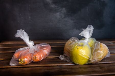 concept plastic free fruits and vegetables in plastic bags on a brown background with copy spaceの写真素材