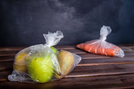 concept plastic free fruits and vegetables in plastic bags on a brown background with copy spaceの写真素材