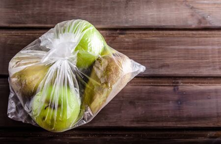 concept plastic free fruit in a plastic bag on brown background with copy spaceの写真素材