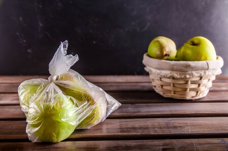 concept plastic free fruit in a plastic bag and wicker basketの写真素材