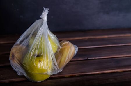 concept plastic free fruit in a plastic bag on brown background with copy spaceの写真素材