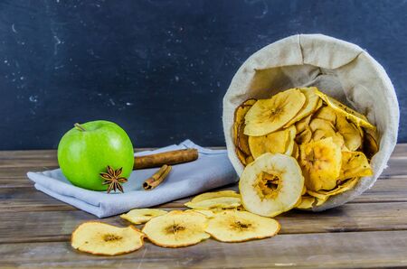 vegetarian apple chips with cinnamon and badyan on a brown backgroundの写真素材