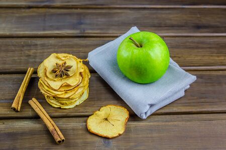 vegetarian apple chips with cinnamon and badyan on a brown backgroundの写真素材