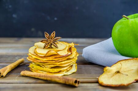 vegetarian apple chips with cinnamon and badyan on a brown backgroundの写真素材