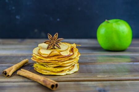 vegetarian apple chips with cinnamon and badyan on a brown backgroundの写真素材