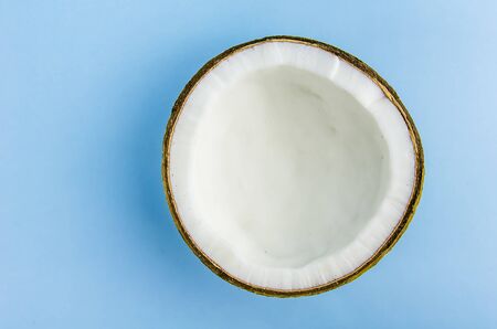 split coconut lies against a blue background