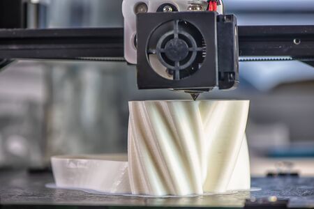 The 3D printer prints the model out of white plastic. modern technology.の写真素材