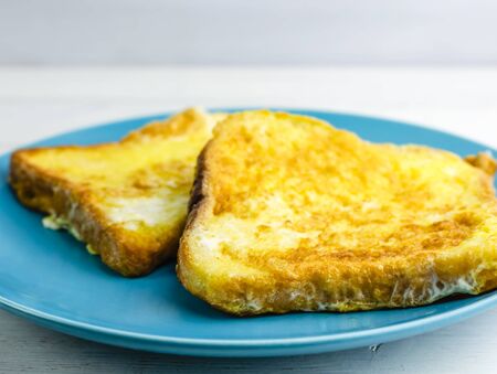 toast in an egg on a blue plate. Breakfast. copy space