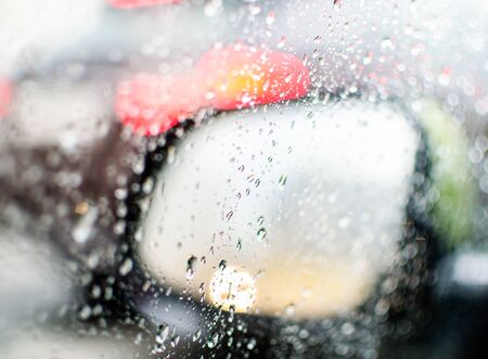 side mirror of the car mobolism in the rain. drops, glass, road