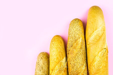 Four different baguettes on a pink background