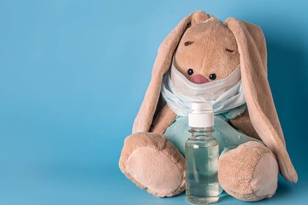 toy bunny in a medical mask with antiseptic