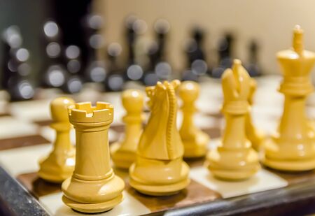 close chessboard with black and white figures.