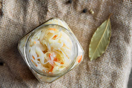 fermented vegetables on sackcloth. Sauerkraut. carrots, pepperの写真素材