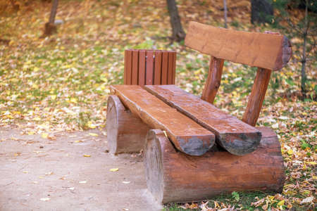 wooden bench in the park in autumnの写真素材
