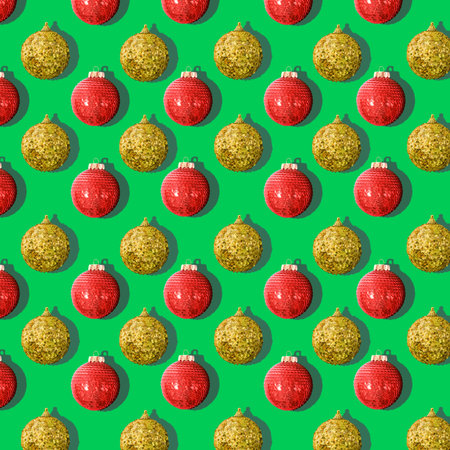 pattern of Christmas tree balls red and gold on a green backgroundの写真素材