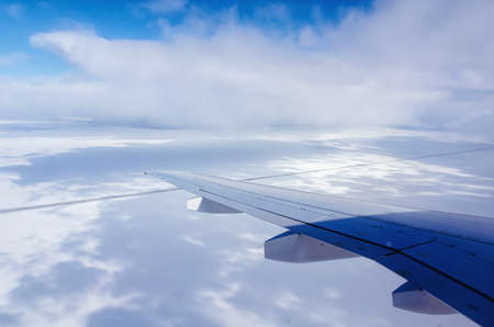 view from the plane on the wing of the plane and the cloudsの写真素材