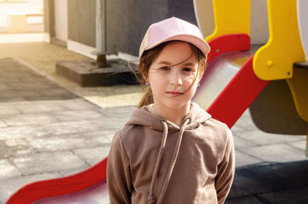 Cute girl walks in the playground in sunny weatherの写真素材
