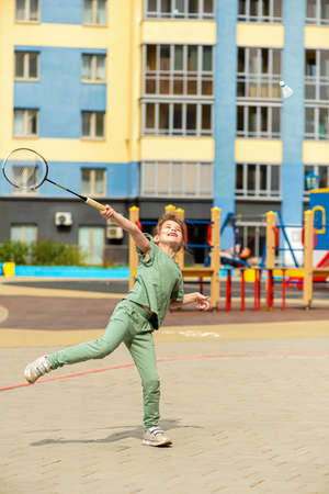 Cute little girl plays in the yard in badmintonの写真素材