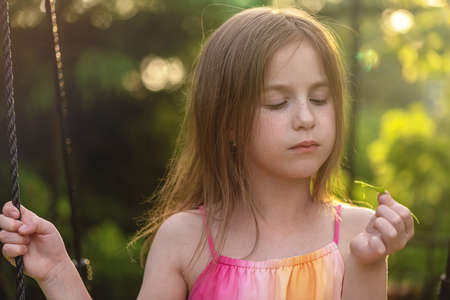 little cute Girl eats green leaf of sorrelの写真素材