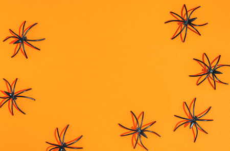 orange halloween background. many black spiders crawlingの写真素材