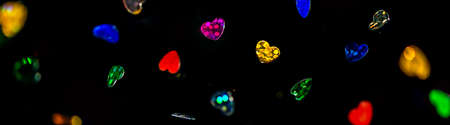 flying multi-colored hearts on the black backgroundの写真素材