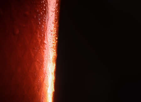 background. close up. drops on a glass with an orange drinkの写真素材