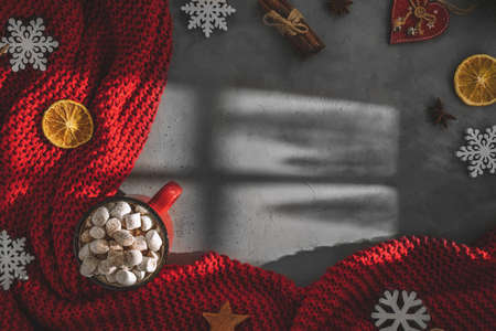 mug with drink marshmallow, red blanket on a gray backgroundの写真素材