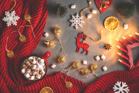 mug with drink marshmallow, garlands, red blanket on a gray backgroundの写真素材