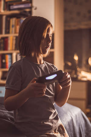 cute girl at home playing a game consoleの写真素材