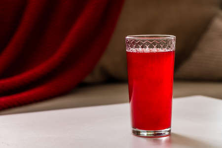 red lingonberry cranberry juice is on the table