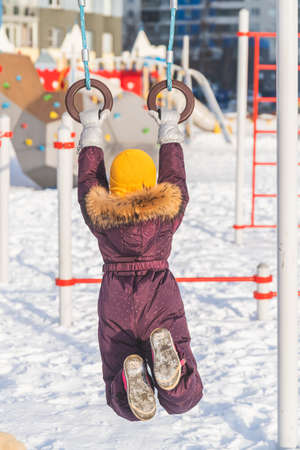 a girl in winter is engaged in sports simulators