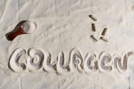 Collagen powder and pills background closeup. Collagen inscriptionの写真素材