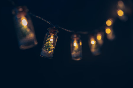Christmas garlands with Christmas trees in bottles on a dark blue background. New Year, Christmas, winter backgroundの写真素材