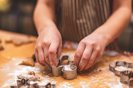 girl makes ginger cookies with Christmas cookie forms. christmas, new year homemadeの写真素材
