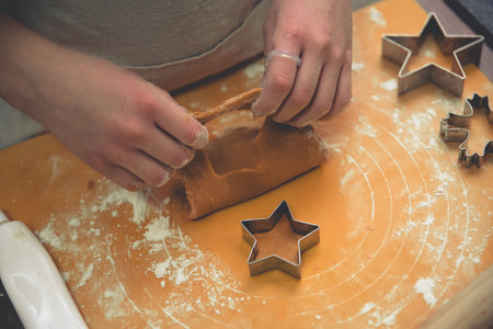 girl makes ginger cookies with Christmas cookie forms. christmas, new year homemade
