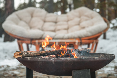 fire campfire bowl outdoors in winter, couch. cozy atmosphereの写真素材