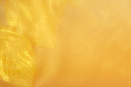 golden leaves on Yellow Golden Shiny Abstract Background. Paints, Acrylic, Glitter in Water. golden...
