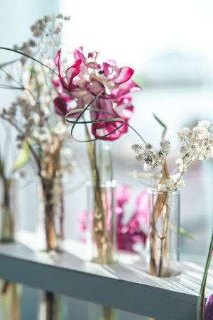 delicate composition of dried withered flowers on the windowsill near the window